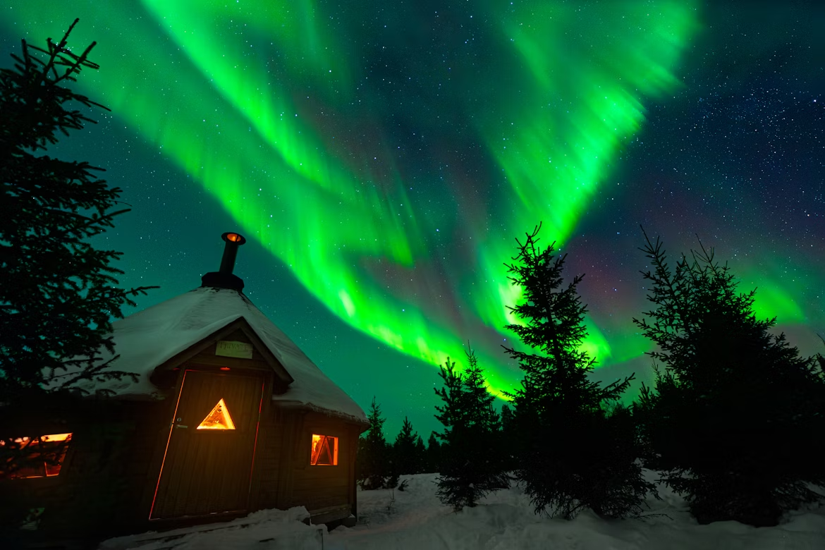 Affordable Northern Lights trip with colorful aurora over snowy landscape
