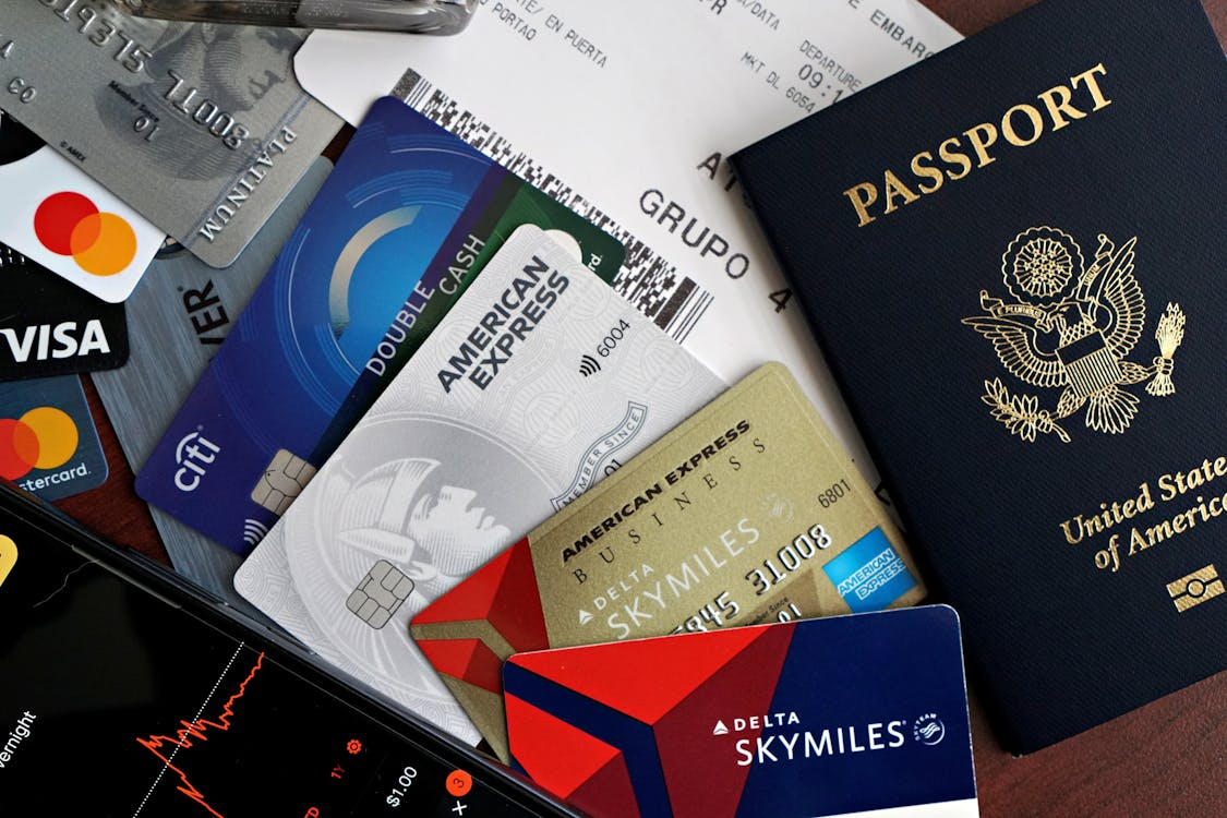 Credit cards, passport, and airline miles card showing how to use credit card points for flights