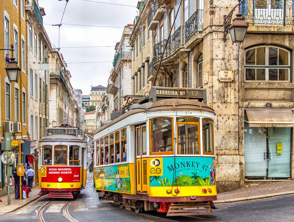 Lisbon historic yellow trams offering affordable public transportation for tourists in Portugal